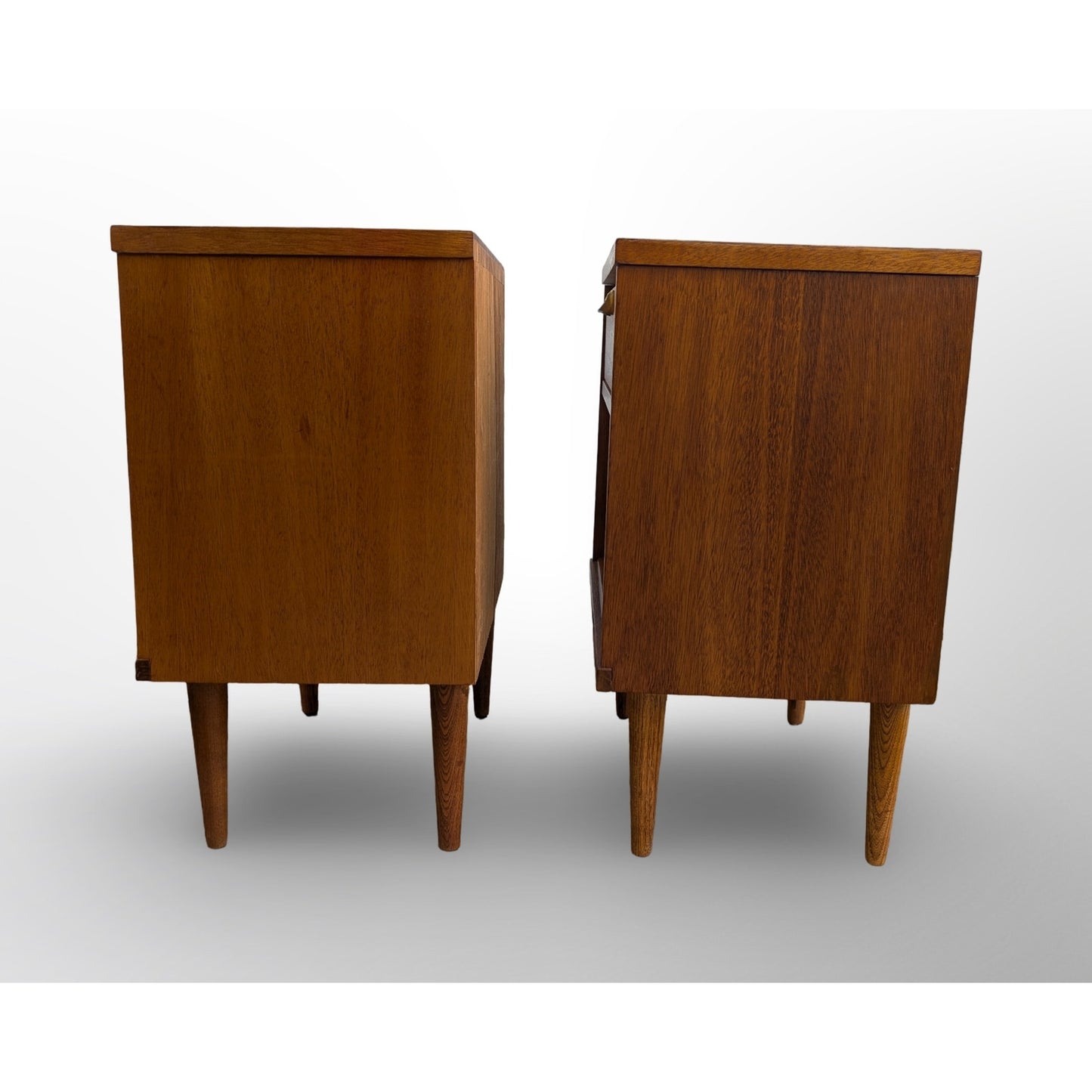 Pair of restored mid century modern walnut nightstands with brass pulls and minimalist design