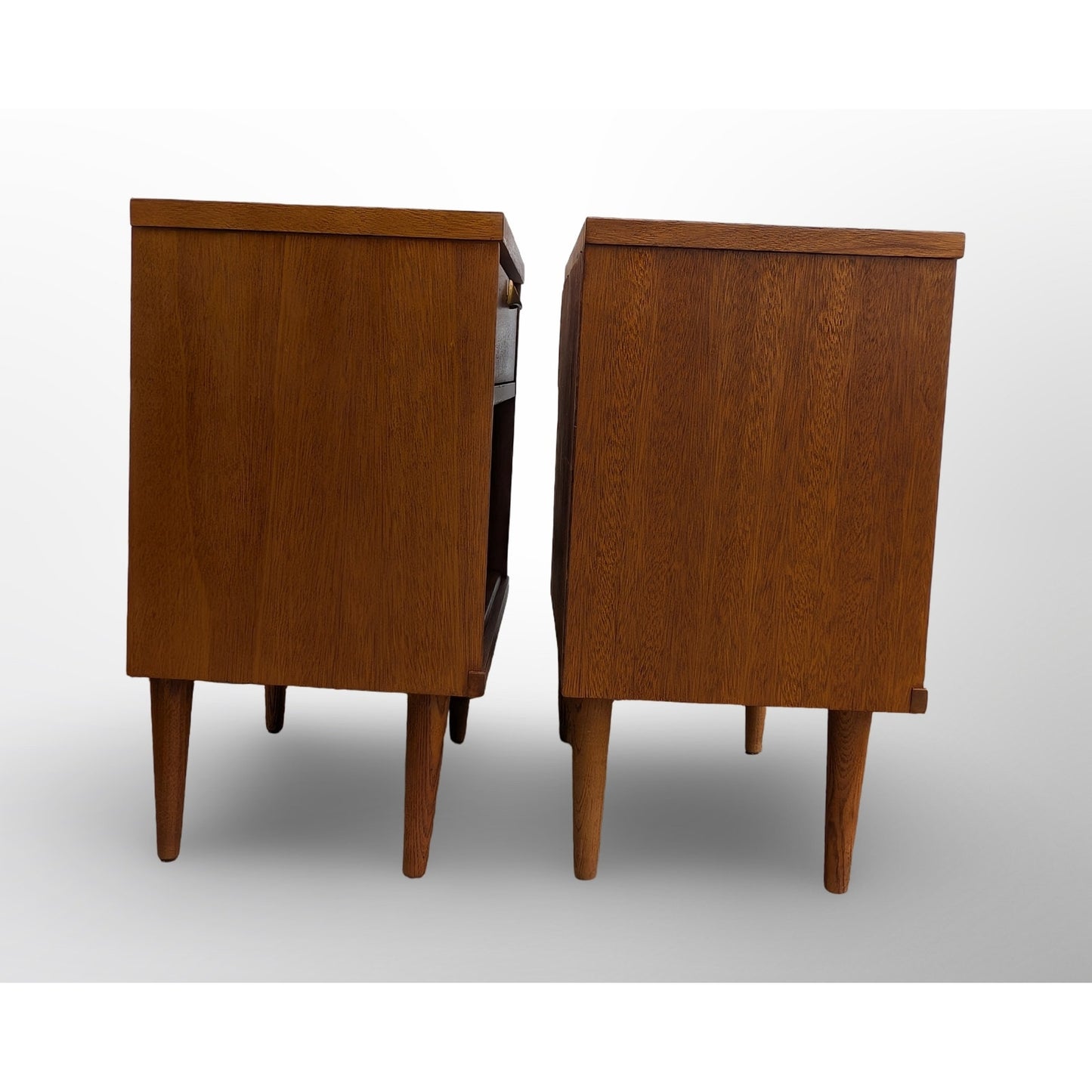 Pair of restored mid century modern walnut nightstands with brass pulls and two drawers for bedroom storage