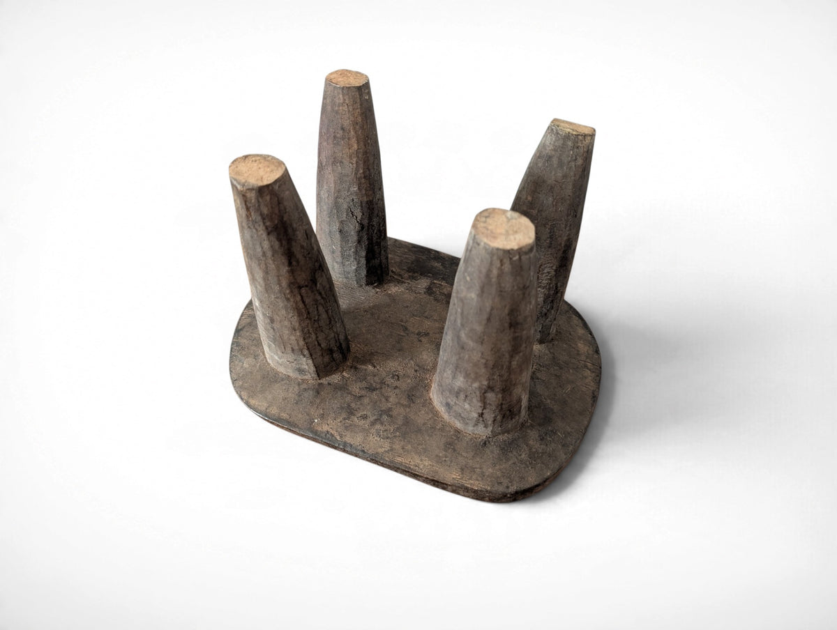 Vintage rustic African Senufo stool with four tapered legs and carved wood seat, 13.25 x 9.75 x 8.75 inches tall
