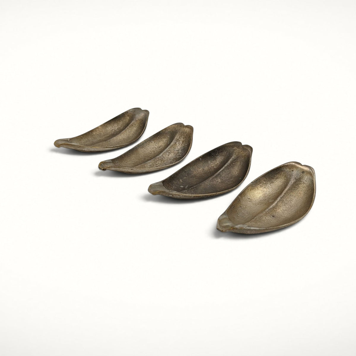 Set of 4 S. Agudo pewter ashtrays, row, low angle view