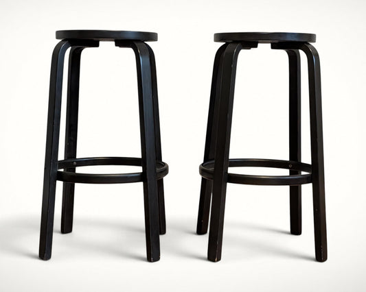 Artek Alvar Aalto Stool 64 black lacquer bar stools, pair, three-quarter view