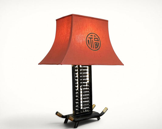 Chinese abacus table lamp with red silk pagoda shade, front view
