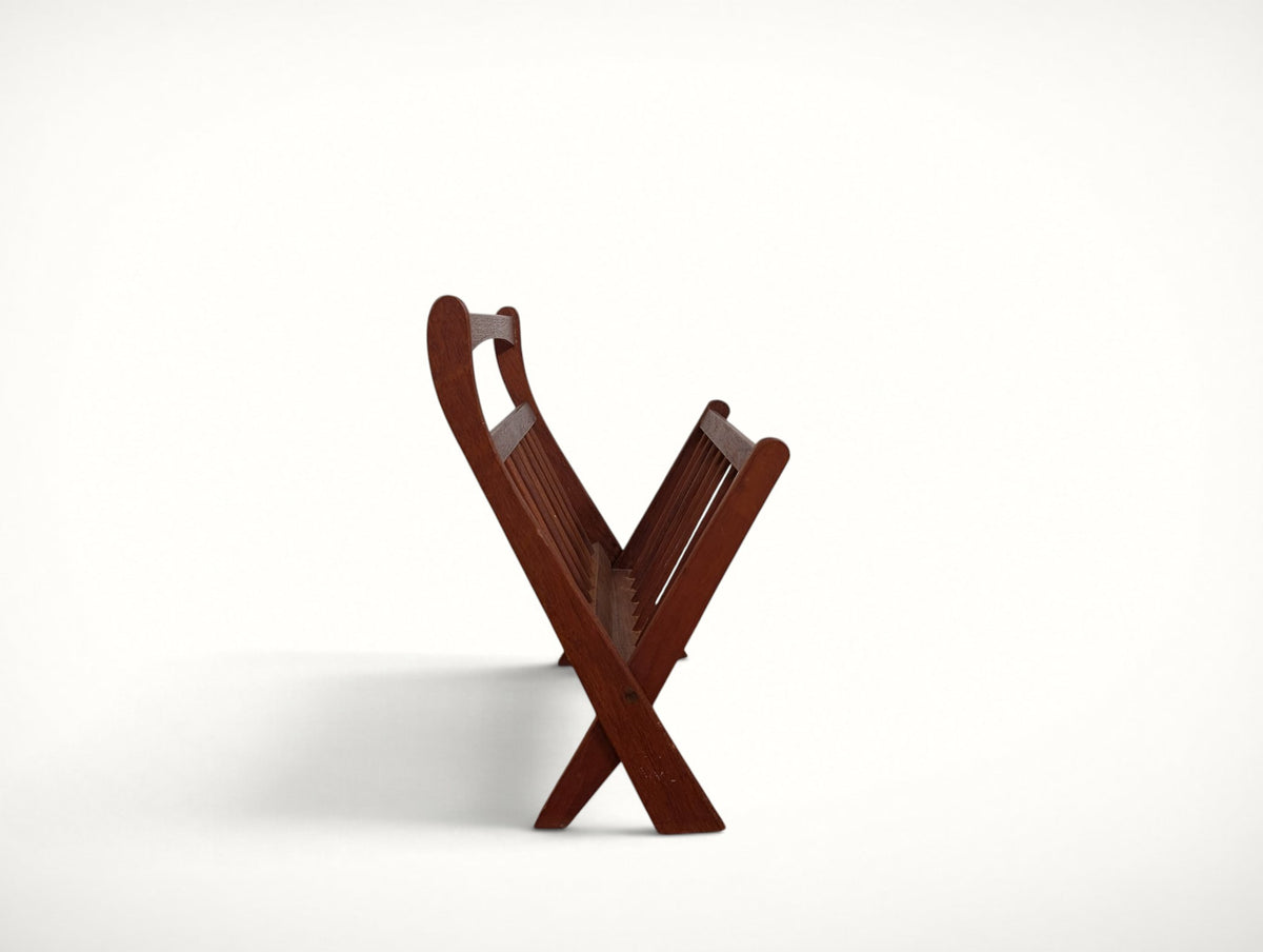 End profile of the folding teak magazine rack showing the X-frame construction