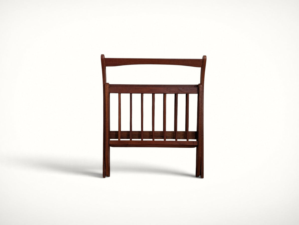 The Danish teak magazine rack folded flat for storage or shipping