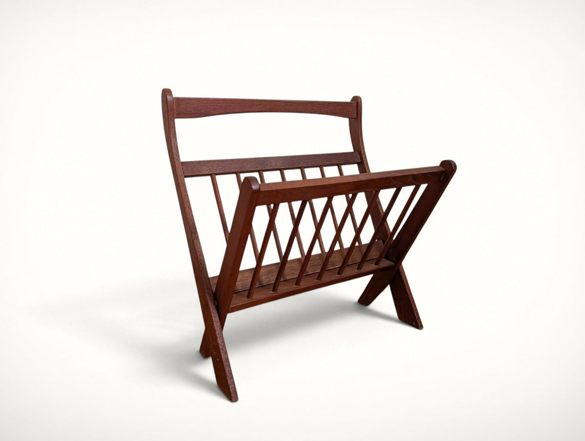 Front view of the vintage Danish teak folding magazine rack — spindle sides, curved top rail, solid teak