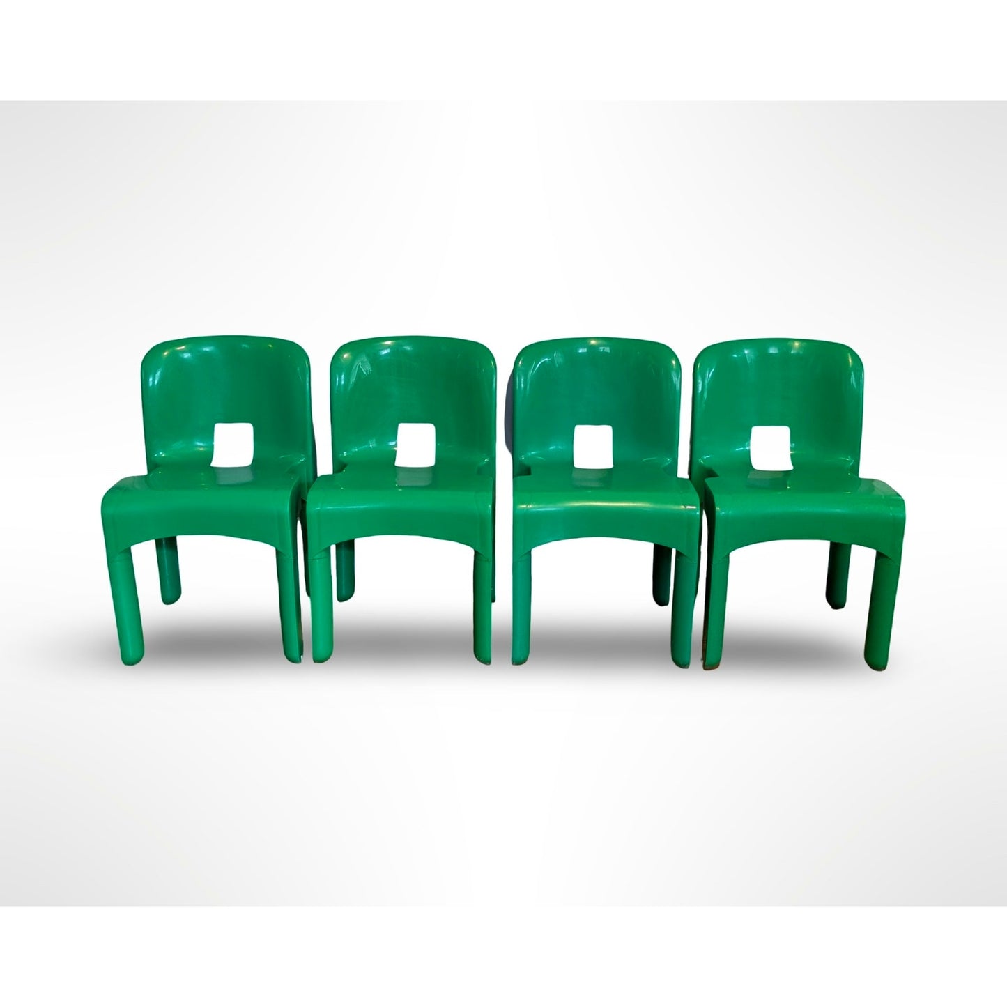 Set of four Joe Colombo Universale Model 4868 chairs for Kartell in green injection molded plastic Italian mid century modern design