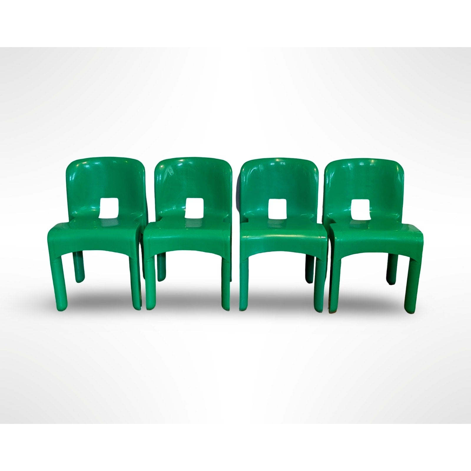 Set of four Joe Colombo Universale Model 4868 chairs for Kartell in green injection molded plastic Italian mid century modern design