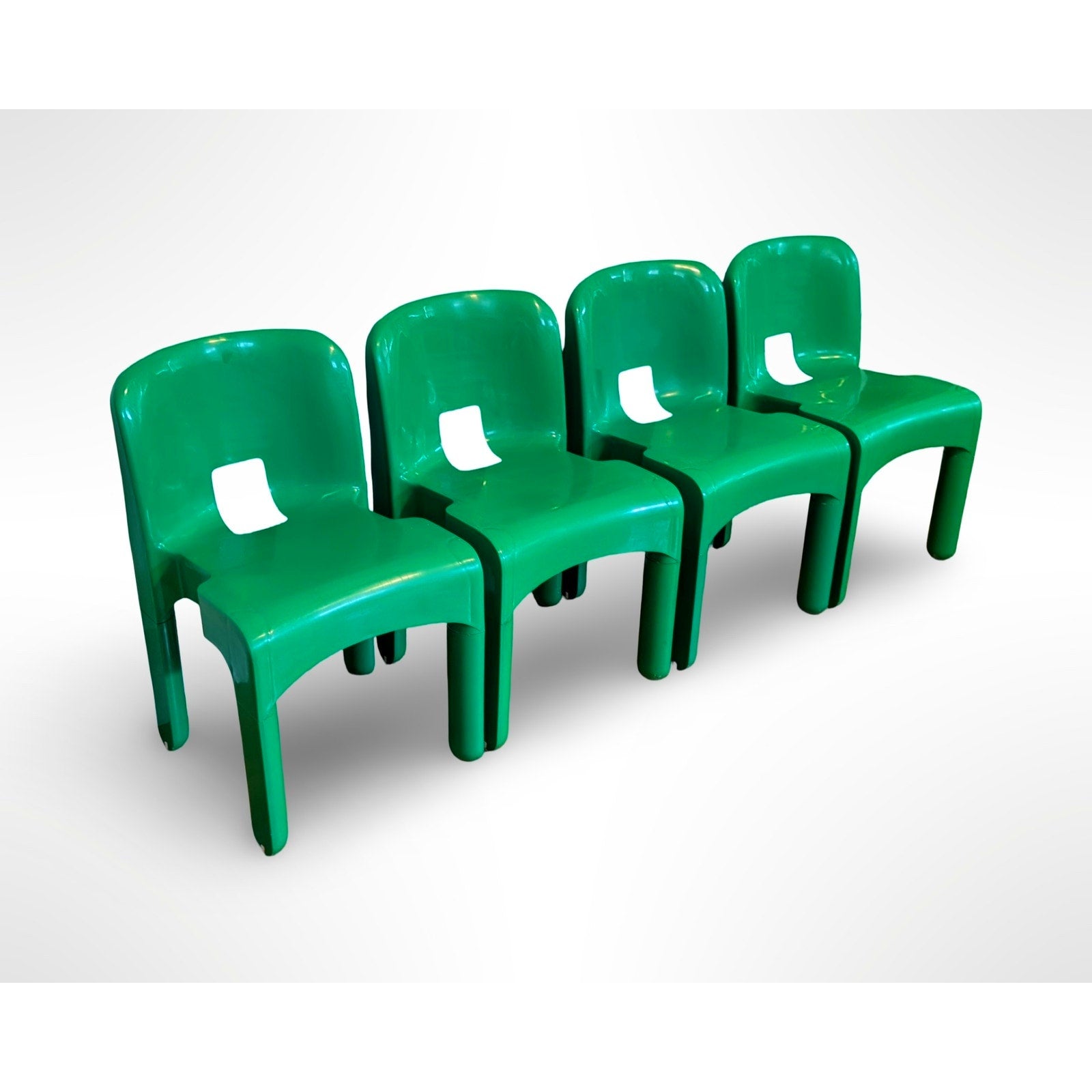 Set of four Joe Colombo Universale Model 4868 chairs for Kartell in green injection molded plastic Italian mid century modern design