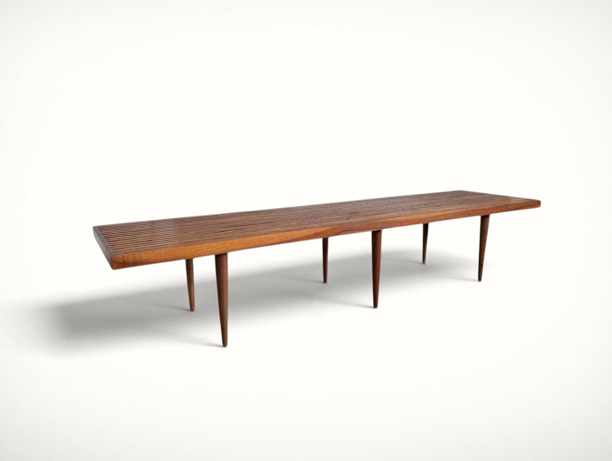 Side profile of the extra long 72 inch slat bench showing all six tapered legs