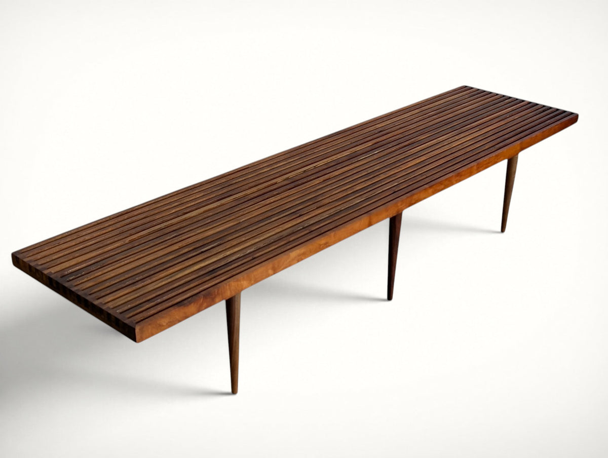 Front angle view of the mid century modern walnut slat bench on six tapered legs