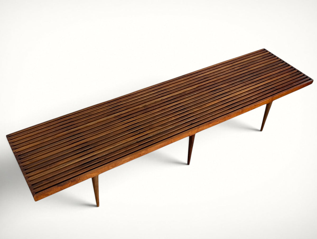 Top angle view of the Mel Smilow slatted walnut bench with finger-jointed ends