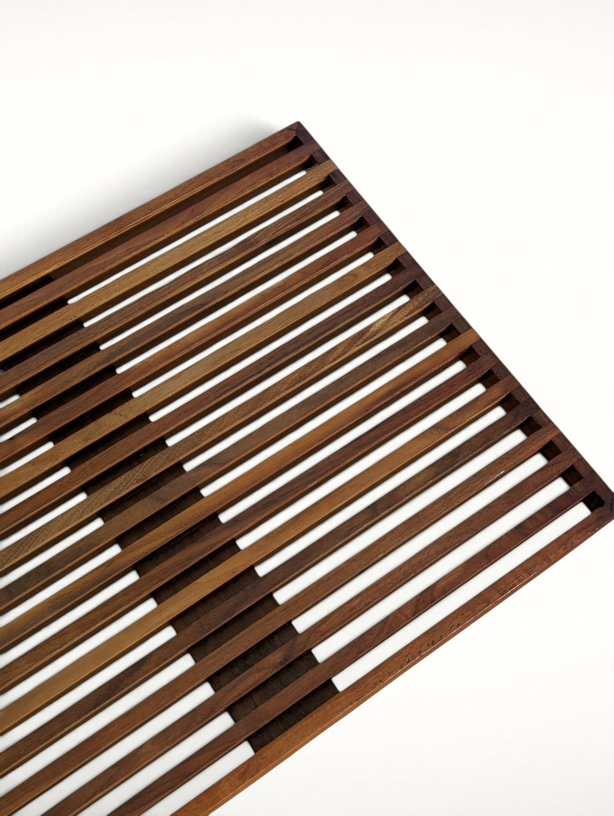 Close-up of the walnut slats and cross support on the Mel Smilow bench top
