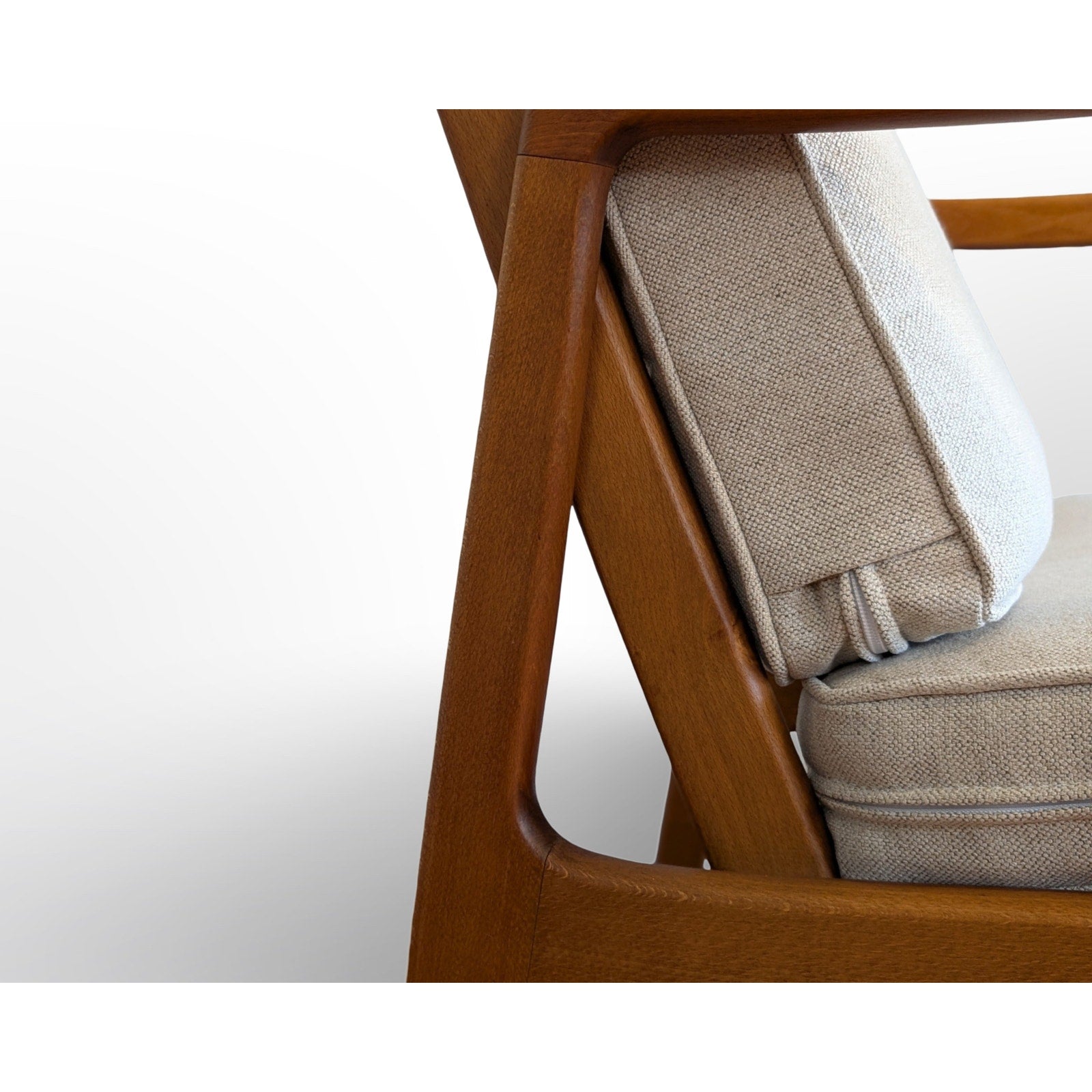 Detail of Ole Wanscher FD109 Danish modern lounge chair showing sculpted wood frame