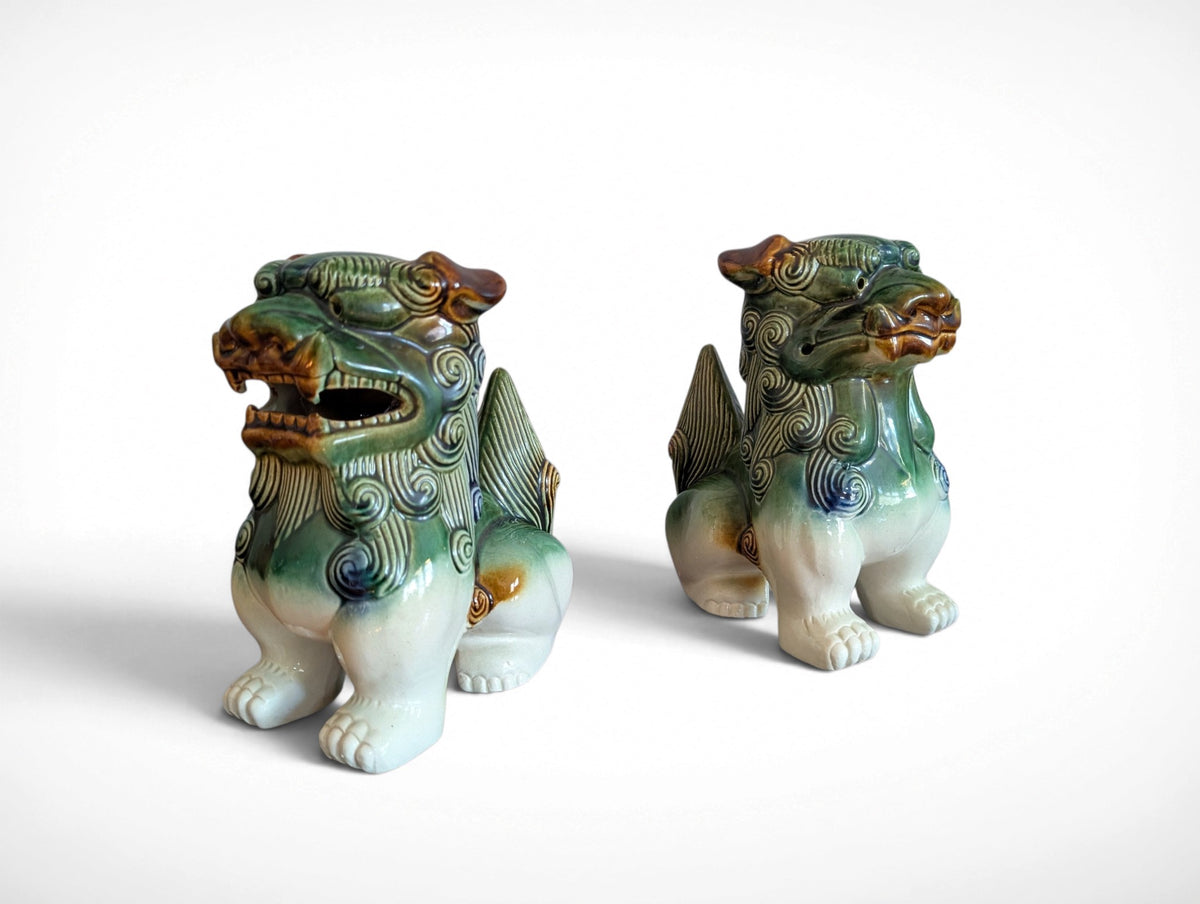 Pair of ceramic Fu dog guardian lion figurines in green, blue and amber glaze, 9.25 inches tall