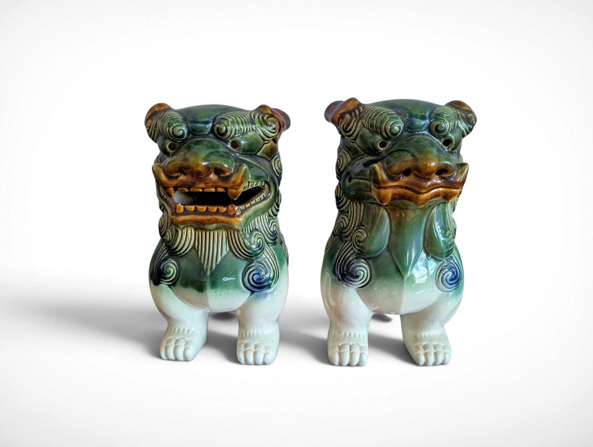 Pair of ceramic Fu dog guardian lion figurines in green, blue and amber glaze, 9.25 inches tall