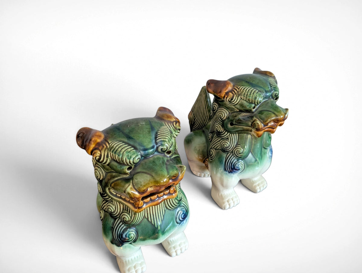 Pair of ceramic Fu dog guardian lion figurines in green, blue and amber glaze, 9.25 inches tall