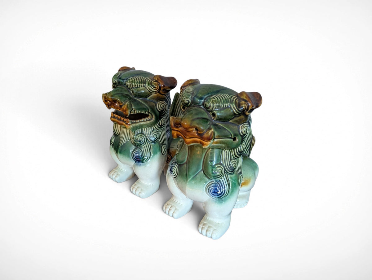 Pair of ceramic Fu dog guardian lion figurines in green, blue and amber glaze, 9.25 inches tall