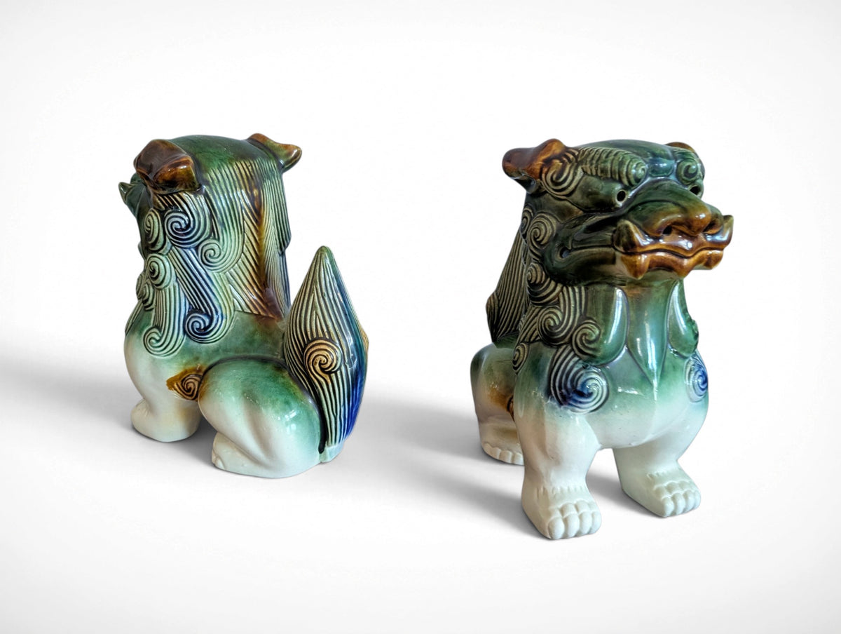 Pair of ceramic Fu dog guardian lion figurines in green, blue and amber glaze, 9.25 inches tall