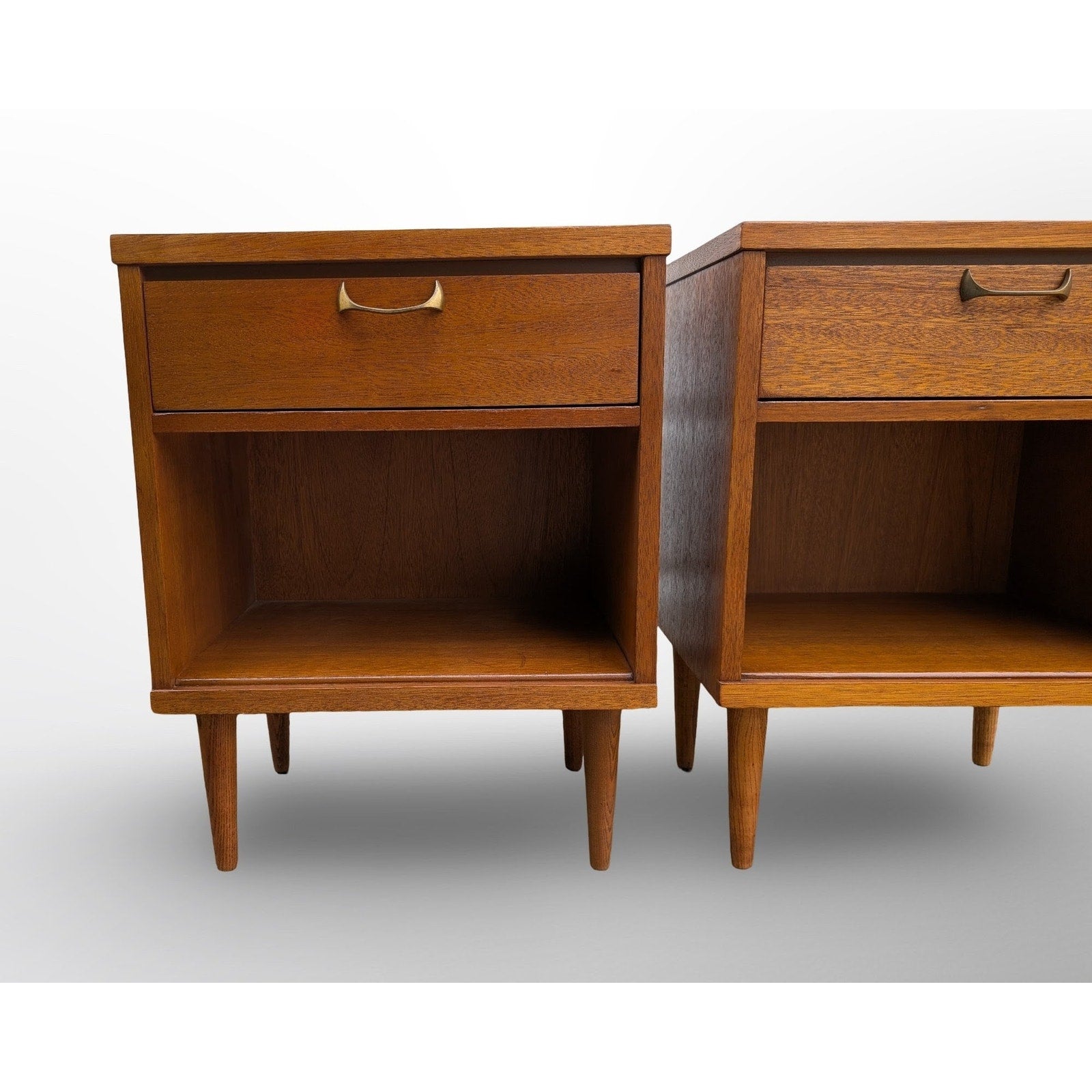 Pair of restored mid century modern walnut nightstands with brass pulls and minimalist design