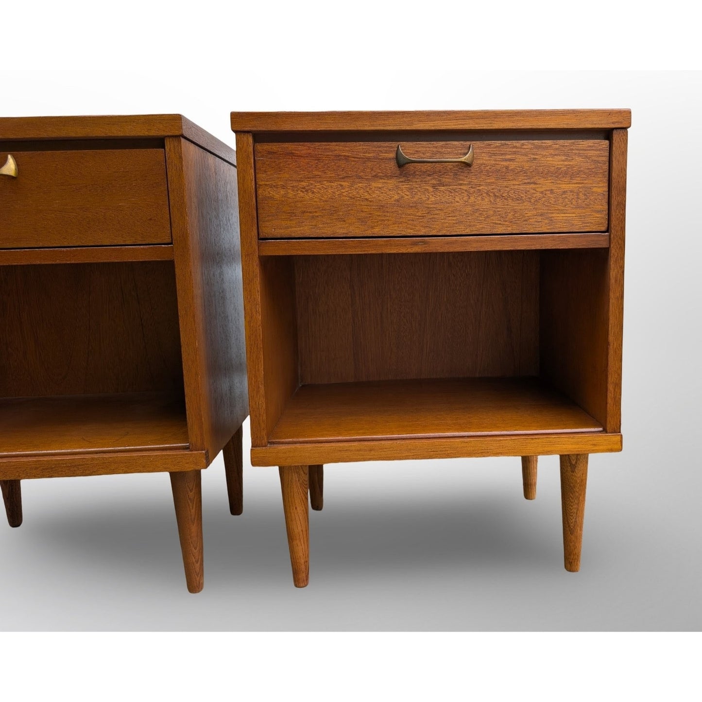 Pair of restored mid century modern walnut nightstands with brass pulls and minimalist design
