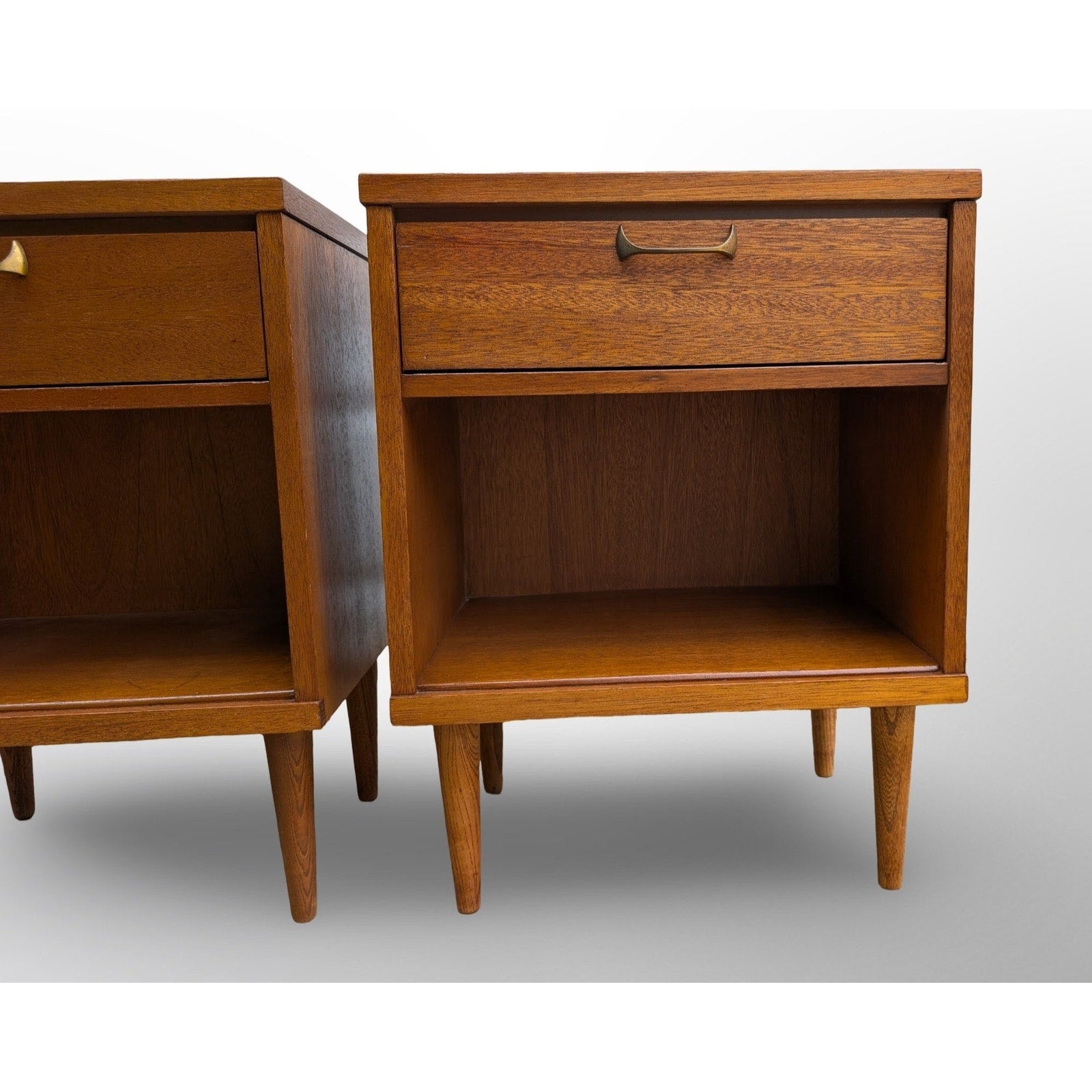Pair of restored mid century modern walnut nightstands with brass pulls and minimalist design