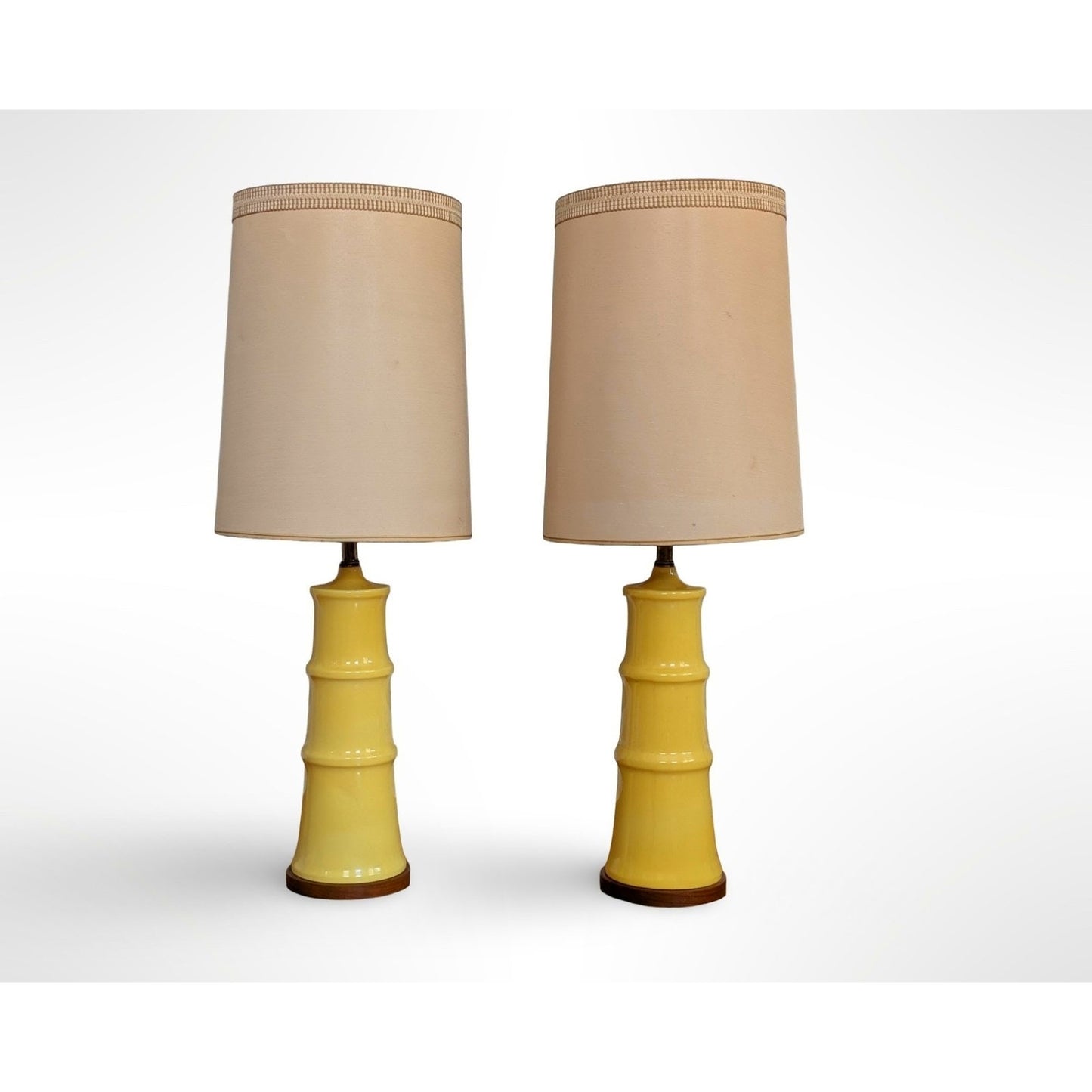 Pair of yellow glazed ceramic table lamps with solid walnut bases and shades in restored mid century modern condition