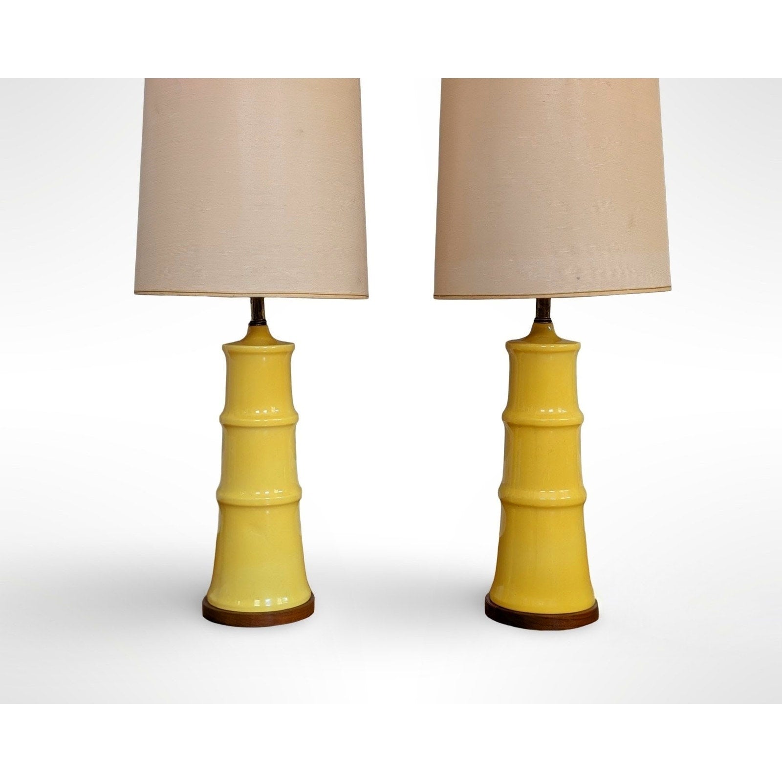 Pair of yellow glazed ceramic table lamps with solid walnut bases and shades in restored mid century modern condition