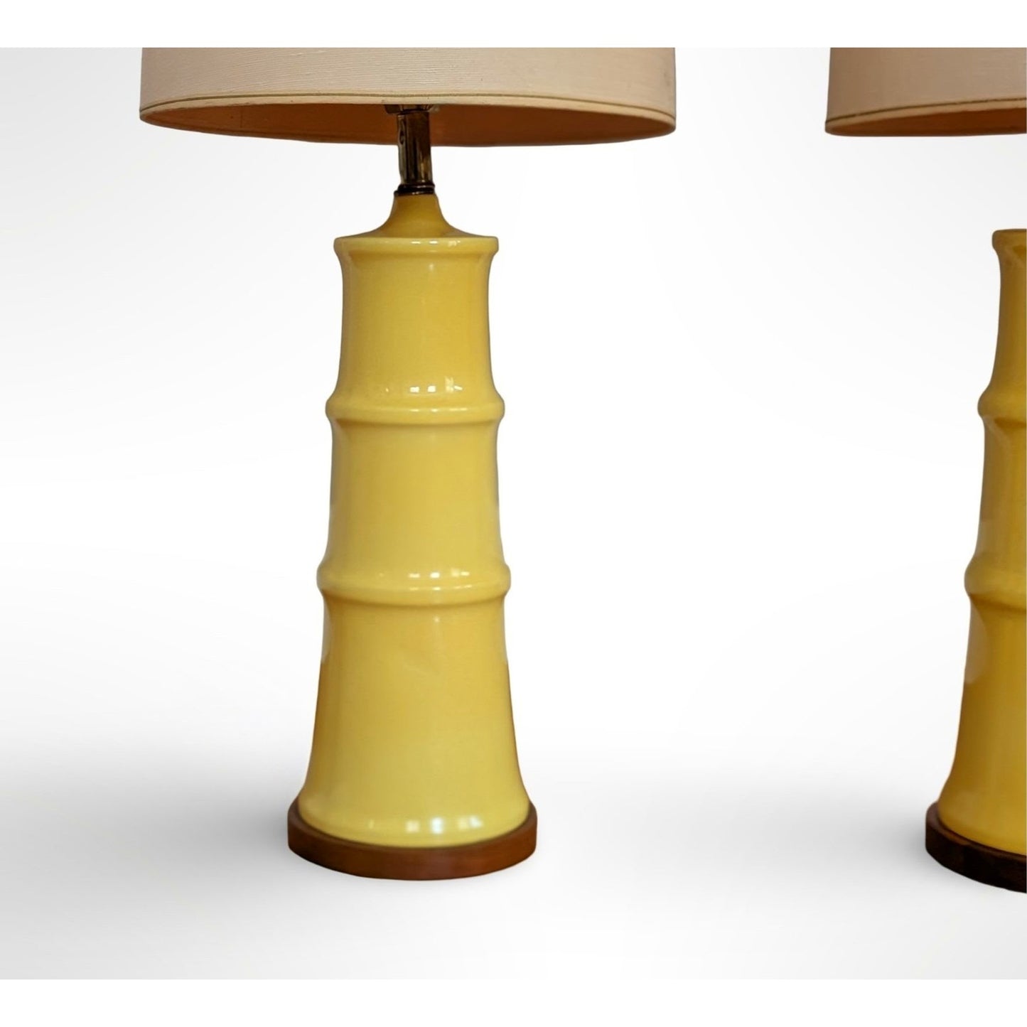 Pair of yellow glazed ceramic table lamps with solid walnut bases and shades in restored mid century modern condition