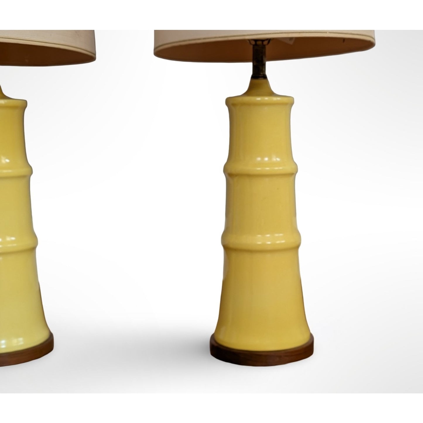 Pair of yellow glazed ceramic table lamps with solid walnut bases and shades in restored mid century modern condition