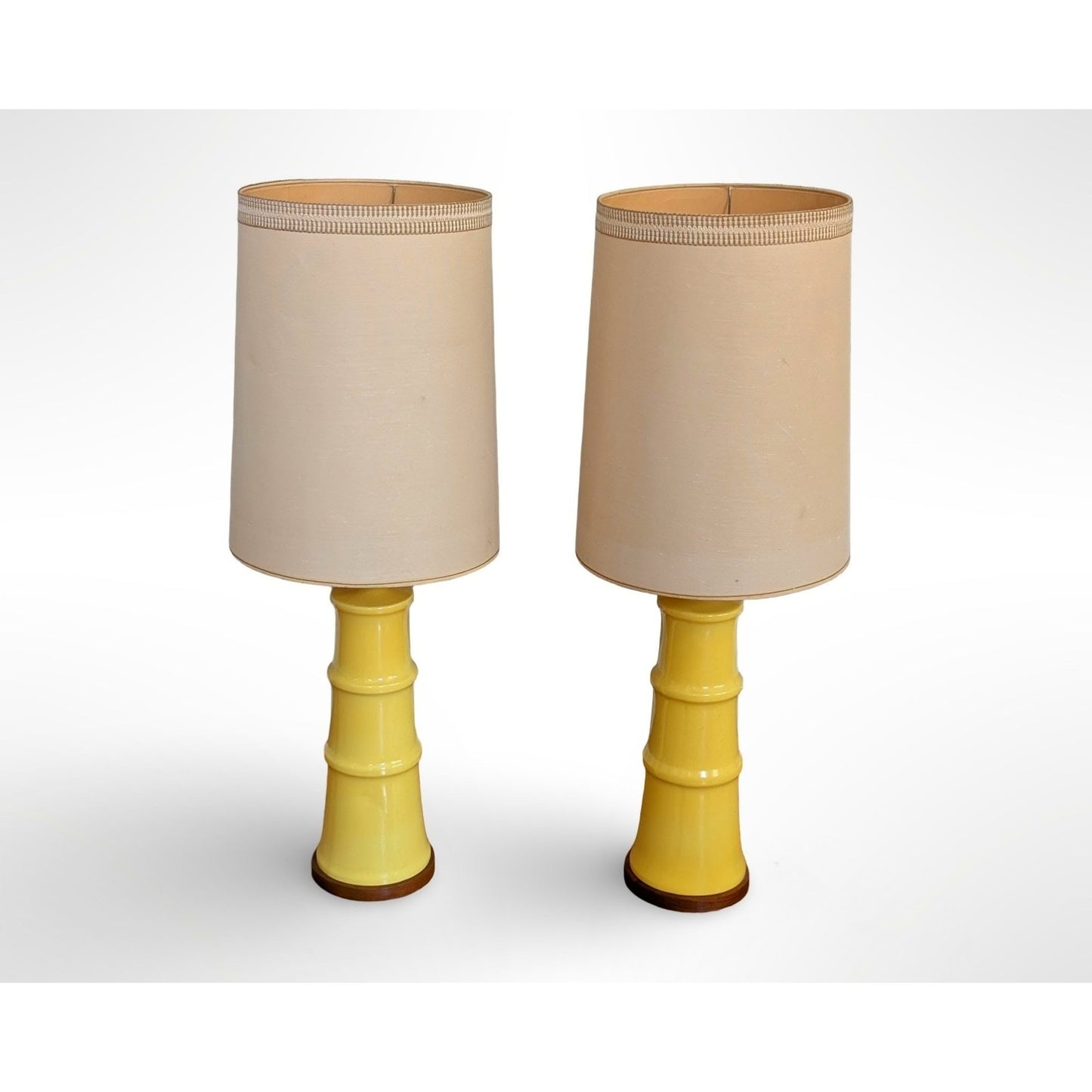 Pair of yellow glazed ceramic table lamps with solid walnut bases and shades in restored mid century modern condition