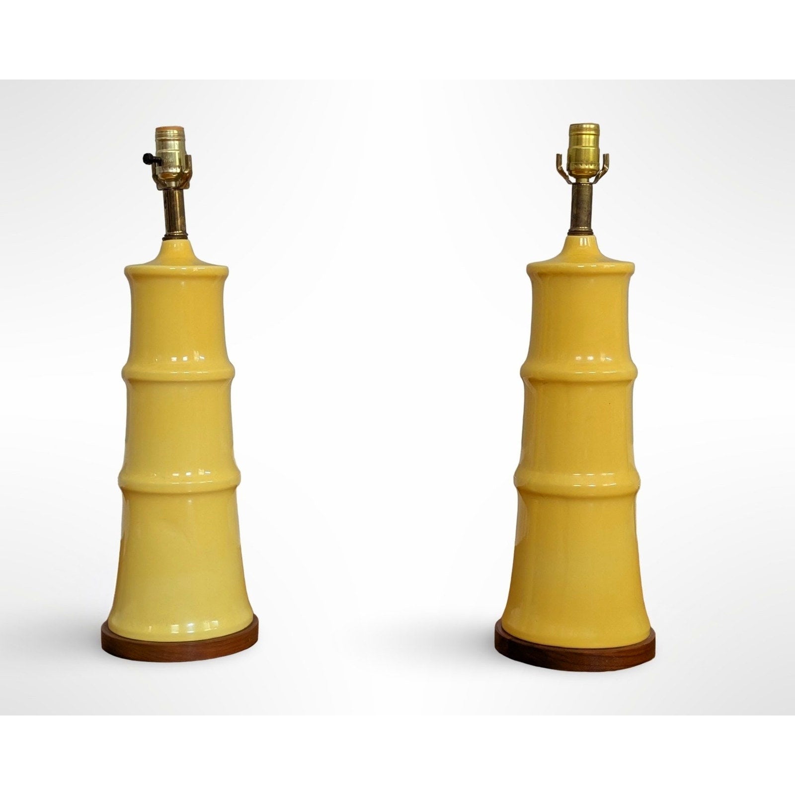 Pair of yellow glazed ceramic table lamps with solid walnut bases and shades in restored mid century modern condition