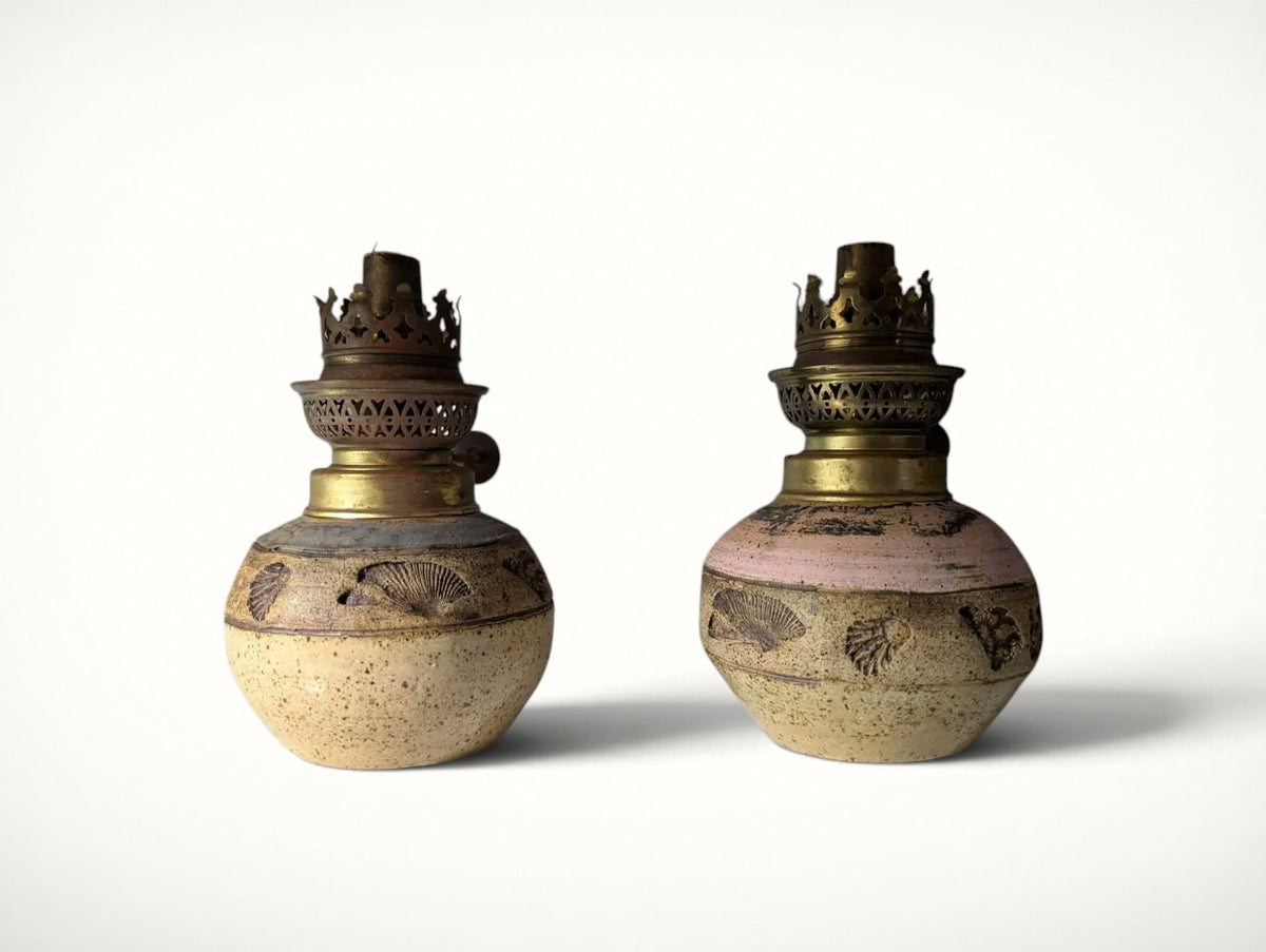 Pair of vintage studio pottery oil lamps with seashell motif, front view