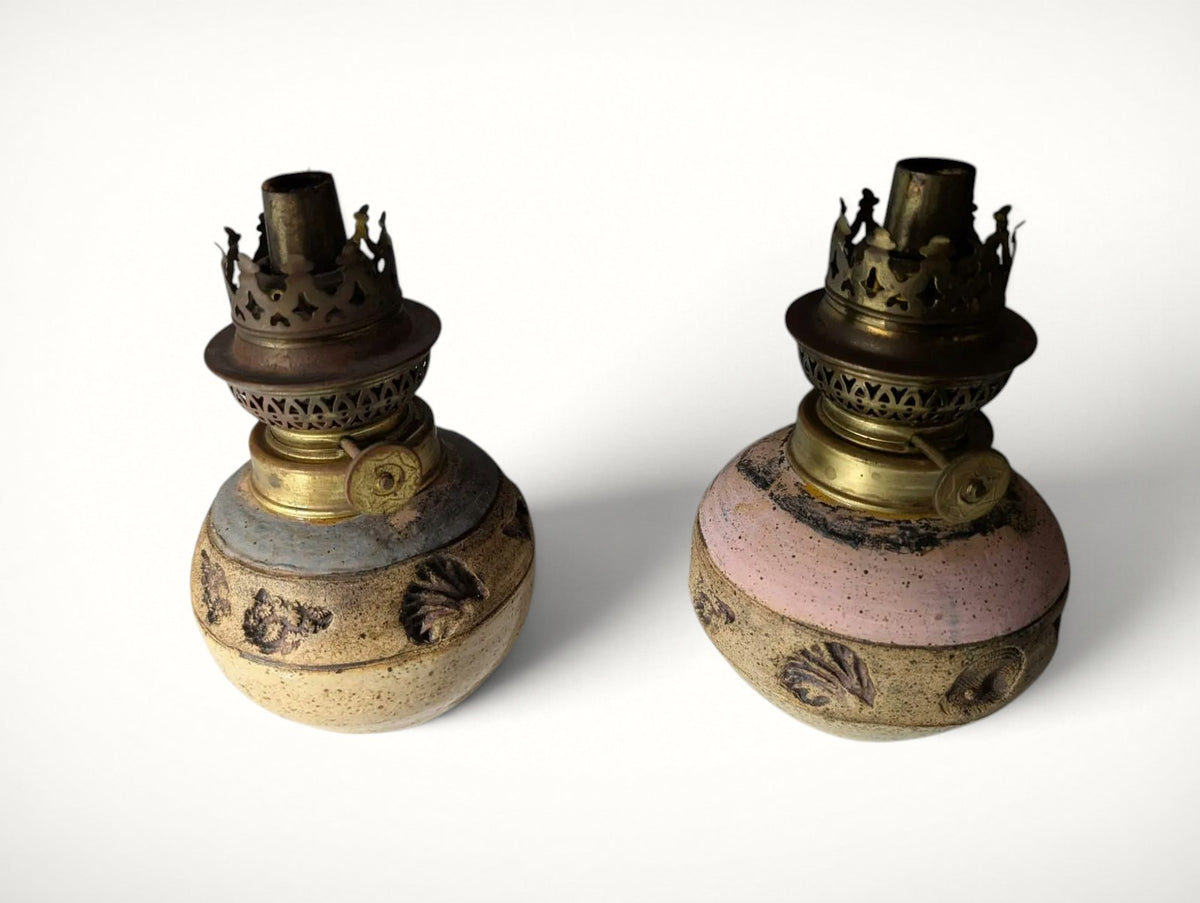 Pair of studio pottery oil lamps, low angle view