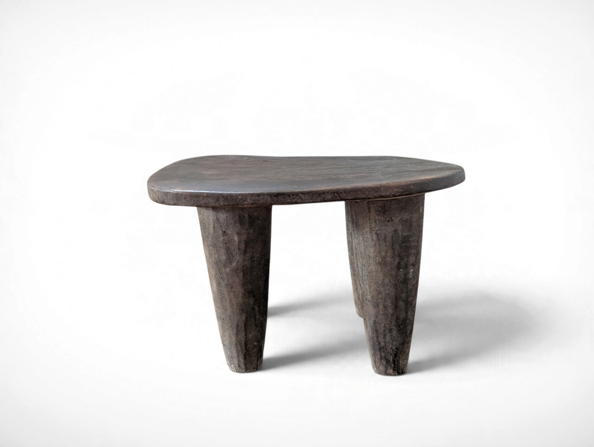 Vintage rustic African Senufo stool with four tapered legs and carved wood seat, 13.25 x 9.75 x 8.75 inches tall