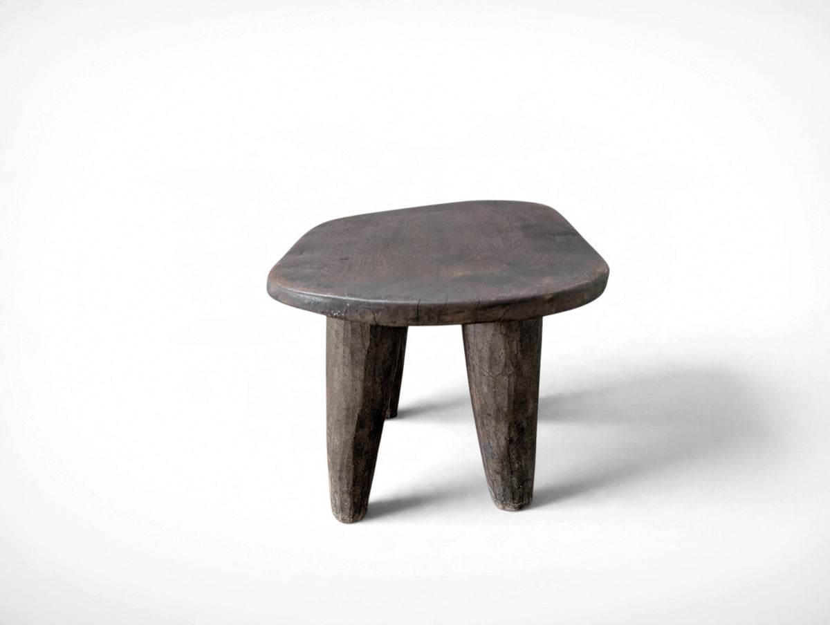 Vintage rustic African Senufo stool with four tapered legs and carved wood seat, 13.25 x 9.75 x 8.75 inches tall