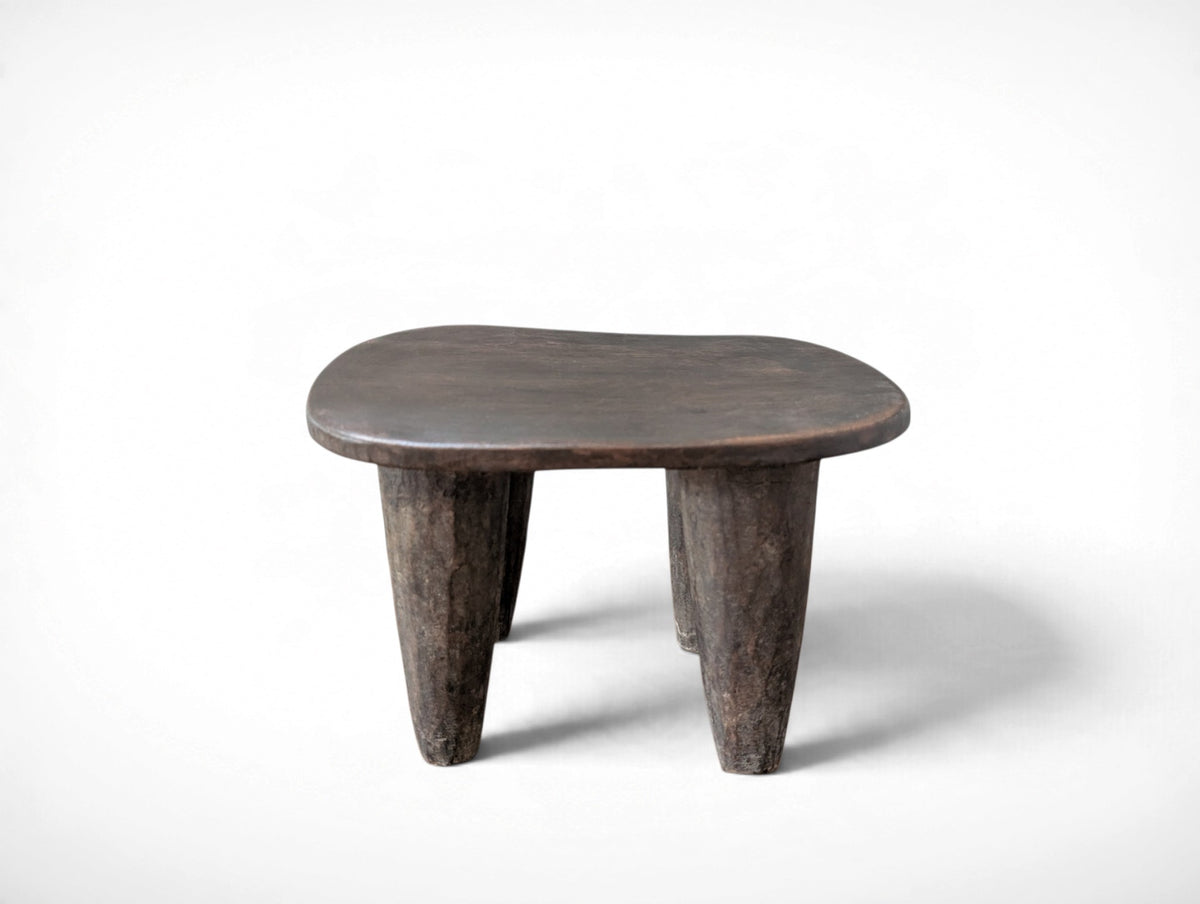 Vintage rustic African Senufo stool with four tapered legs and carved wood seat, 13.25 x 9.75 x 8.75 inches tall