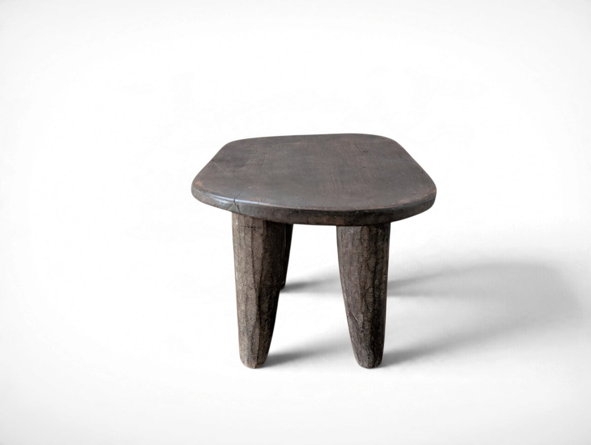 Vintage rustic African Senufo stool with four tapered legs and carved wood seat, 13.25 x 9.75 x 8.75 inches tall