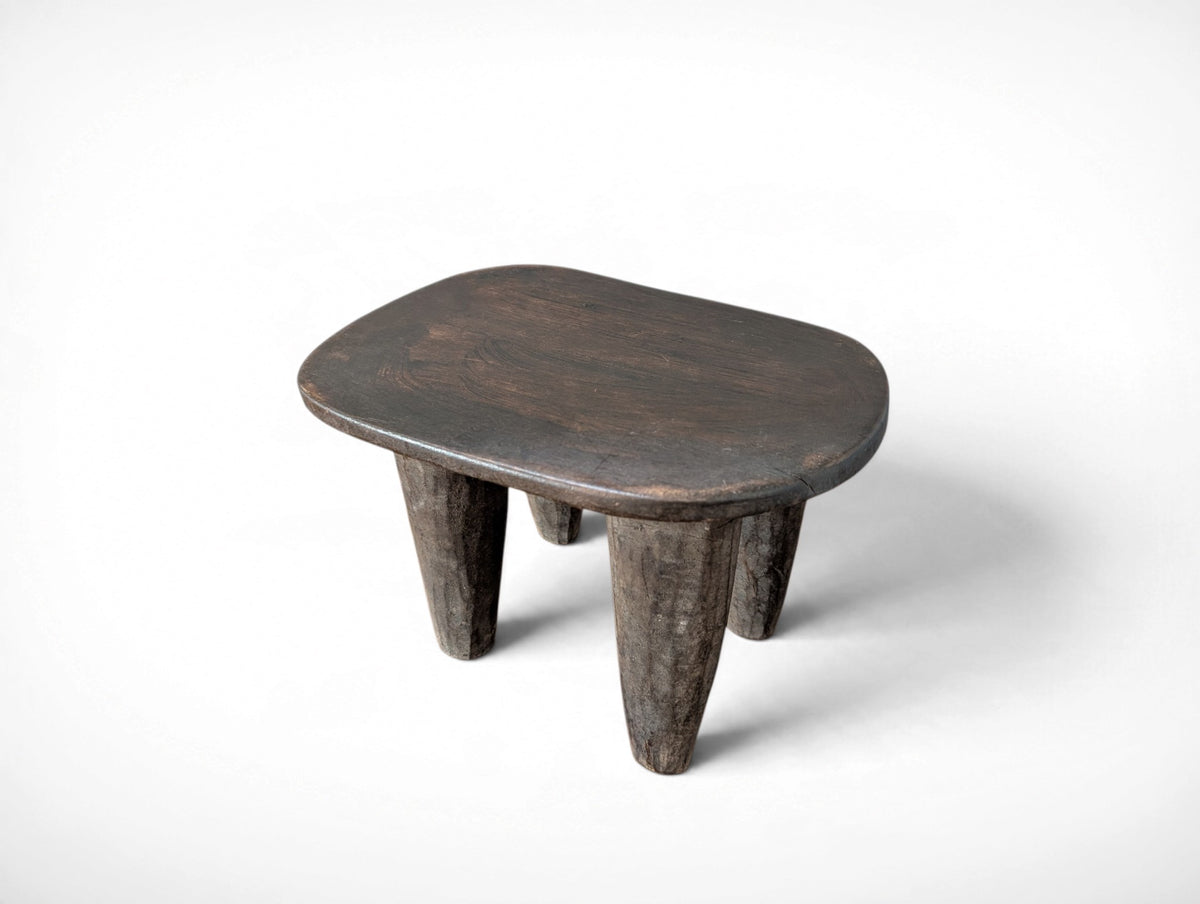 Vintage rustic African Senufo stool with four tapered legs and carved wood seat, 13.25 x 9.75 x 8.75 inches tall