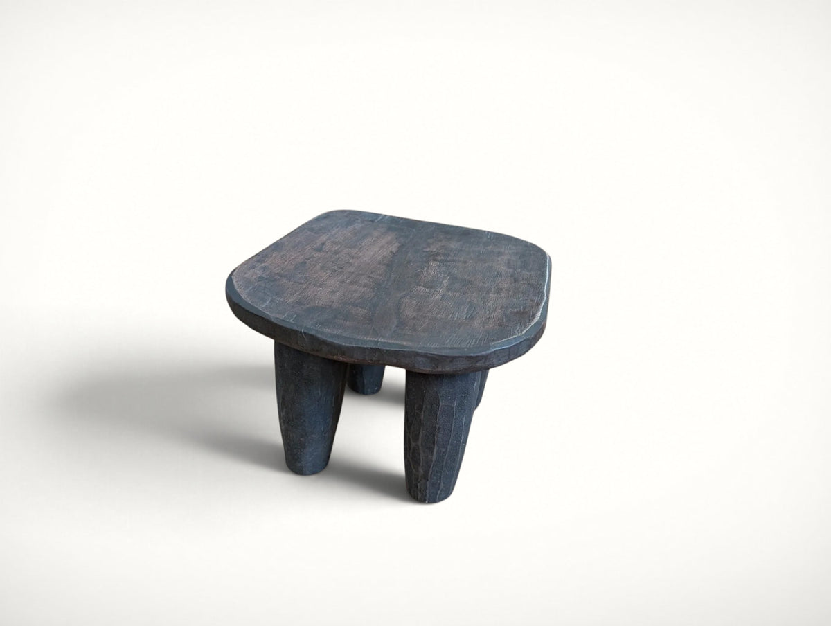 Seat detail of the hand-carved Senufo stool — single piece of solid wood with a gently dished top