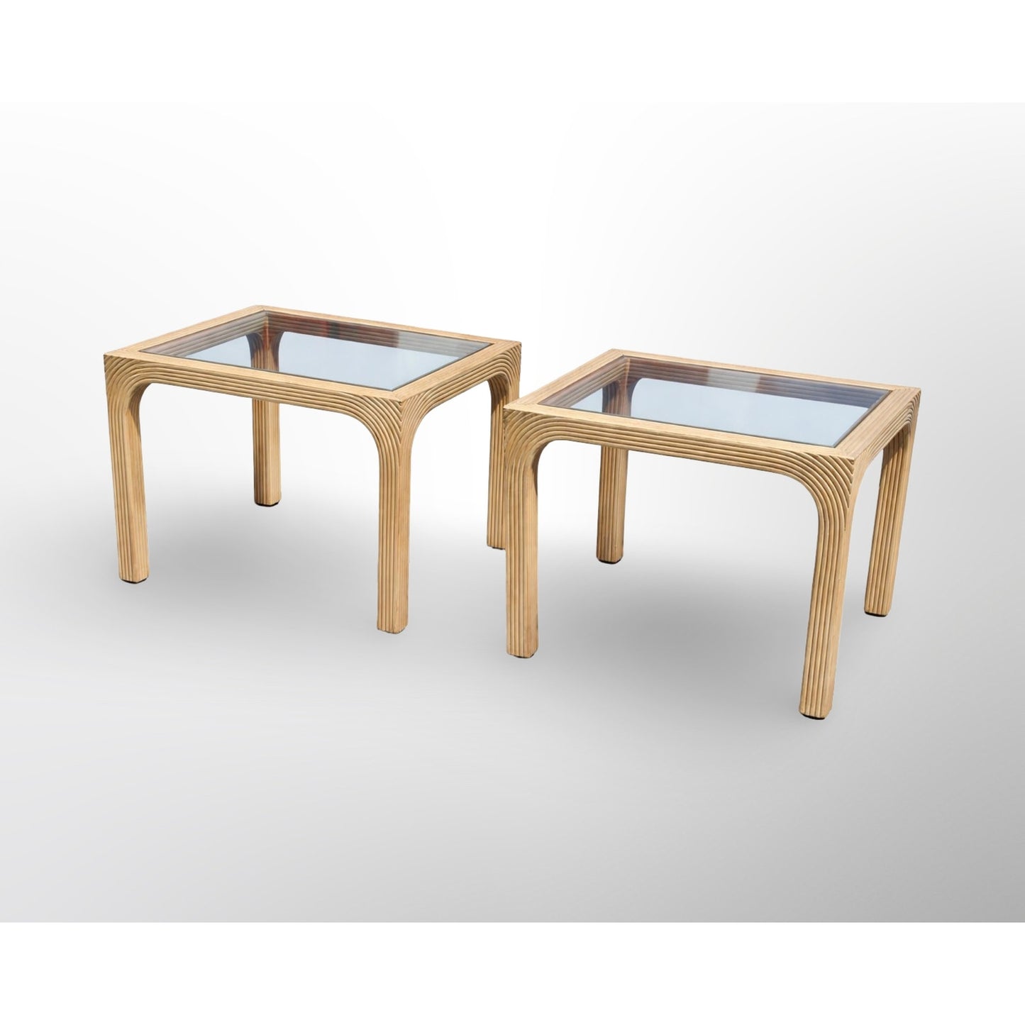Pair of split reed side tables with glass tops in mid century modern rattan design