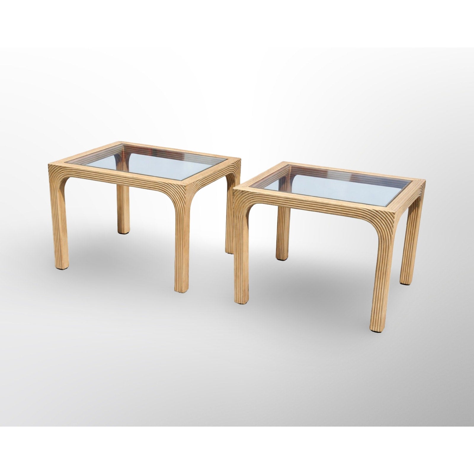Pair of split reed side tables with glass tops in mid century modern rattan design