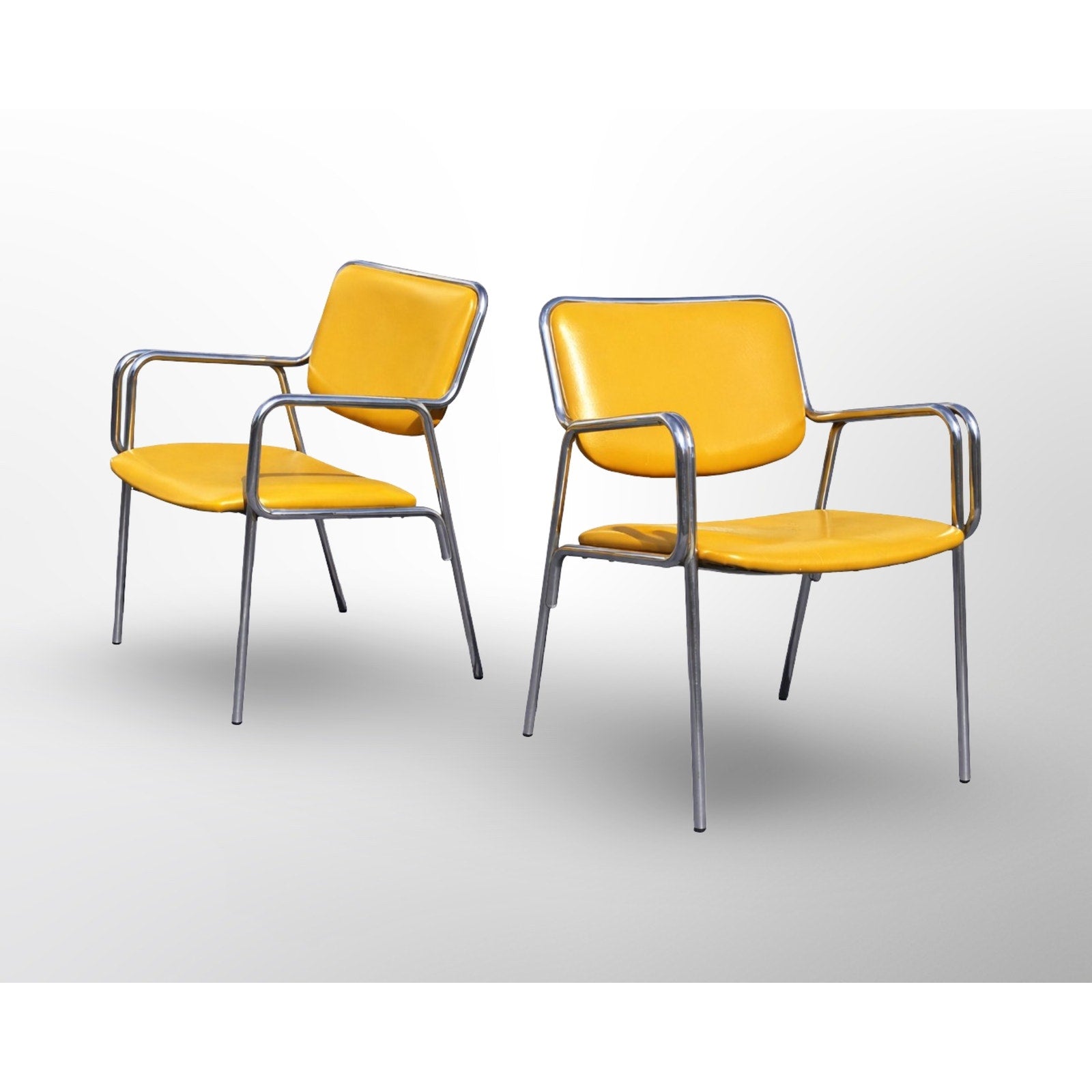 Side profile of chrome cantilever dining chairs in mid century modern style with custom upholstered seats